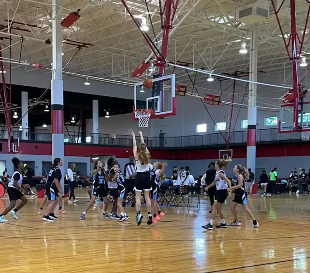 Teams playing across several courts at an AAU event