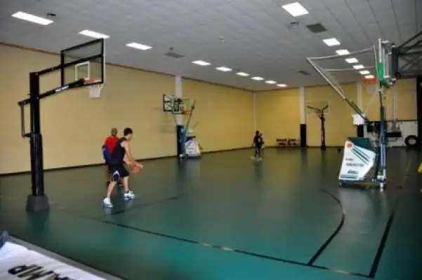 Long view of the old green concrete court inside the warehouse