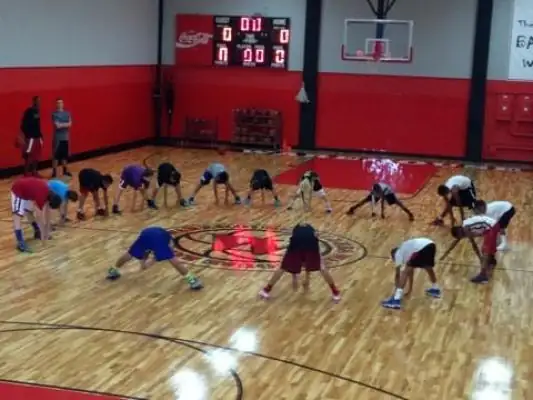 Campers in a stretch circle on the court, June 2014